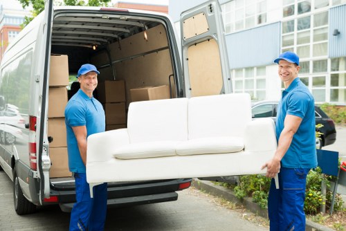 A local packing team organising household boxes during a move in Poplar