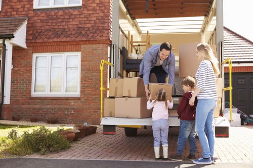 Removal team preparing a flat move in Poplar with boxes and furniture