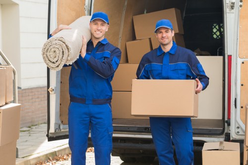 Crew using safe lifting techniques during a man and van move