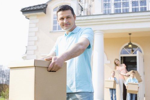 Careful loading of household items into a removal van for a Poplar flat move