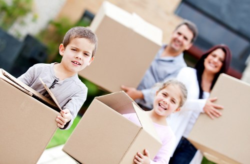 Careful unpacking of kitchen items in a Poplar home after relocation