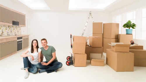 Staff carefully handling household items during a Poplar van move