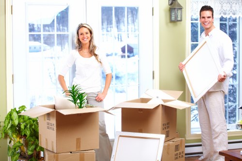 Moving van parked for a scheduled collection with packed items nearby