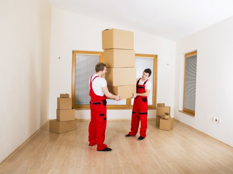 A removals team loading furniture during a Poplar home move