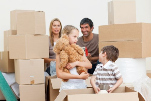 Movers handling furniture in a Poplar apartment block