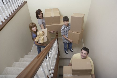 Local removals team handling furniture and boxes near Poplar homes